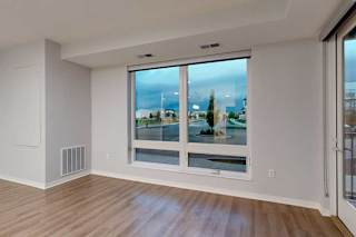 A room with a large window overlooking a cityscape.