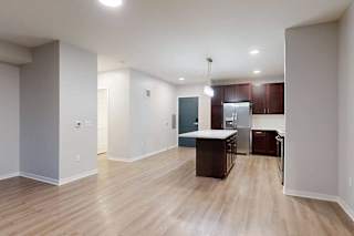 A kitchen area with a counter and cabinets.