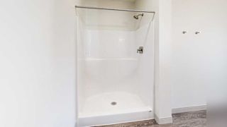 a walk-in shower with built-in shelving