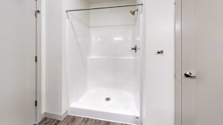 a bathroom with a white walk-in shower