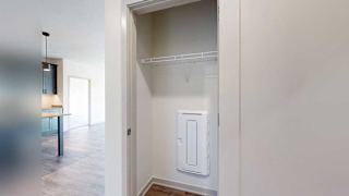 a hallway closet with a built-in shelf