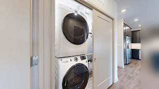 a stackable washer and dryer in a closet