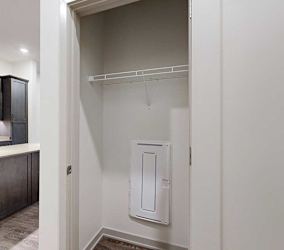 a storage closet with a built-in wire shelf