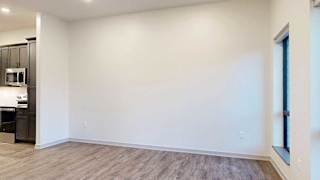 a living room with wooden flooring and white walls
