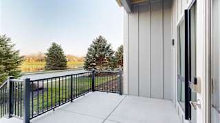 a walk-out patio with a black railing