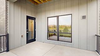 a walk-out patio with a large window and a black windowed door