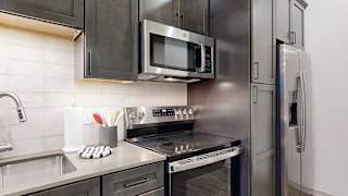 a modern kitchen with stainless steel appliances and a microwave above the stove