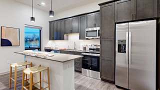 a kitchen with a full-size refrigerator, range, and microwave