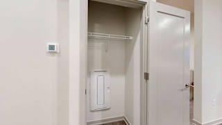 a coat closet in the main entryway of the guest suite