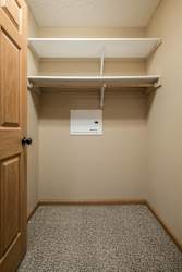 a empty closet with a door and a paper towel dispenser
