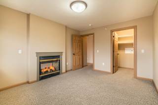 an empty bedroom with a fireplace