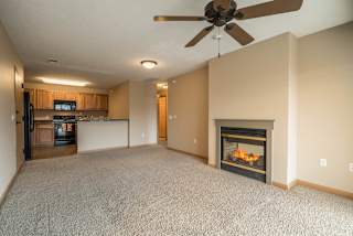 a living room with a fireplace  and a kitchen