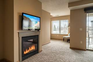 a living room with a fireplace and a tv