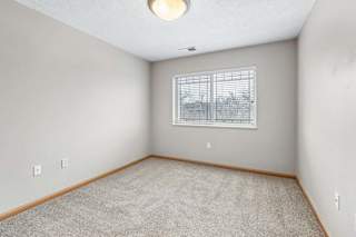 Unfurnished bedroom featuring carpet flooring and single window.