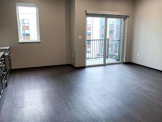Open kitchen into dining room with sliding door leading to deck at Haven at Uptown