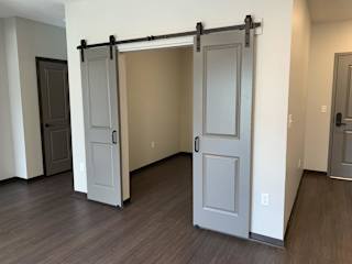 Den or office space with elegant double barn doors at Haven at Uptown
