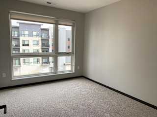 Spacious bedroom with large windows and a lot of natural light in the peace floorplan at Haven at Uptown