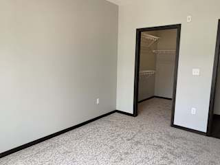 bedroom features spacious walk-in closet with shelving at Haven at Uptown