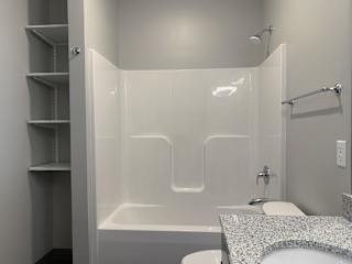 Shower and tub combo with linen storage close by