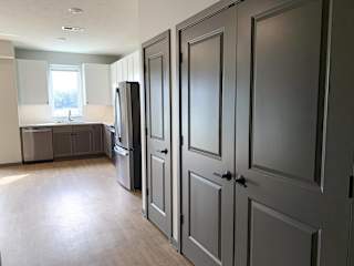 Open kitchen next to spacious storage and laundry closet