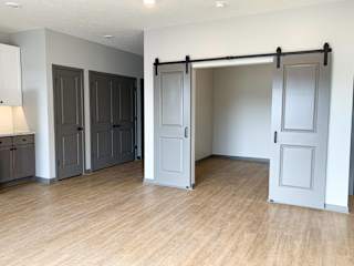Den or office with gray sliding barn doors