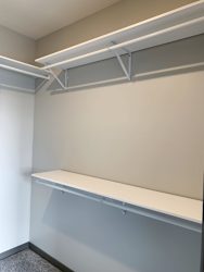 Walk-in closet with shelving and rods in the Serenity floorplan at Haven at Uptown