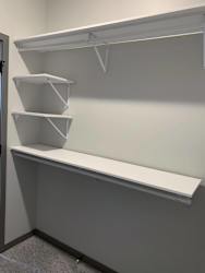 All white shelving and rods in walk in closet in serenity floor plan at Haven at Uptown