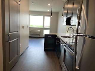 Kitchen leading into dining area in studio at luxury apartment in Lincoln