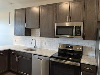 Kitchen with matching stainless steel appliances in Zen floorplan at Haven at Uptown