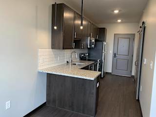 Large L-shaped granite countertop in Zen floorplan at Haven at Uptown