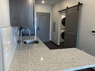 Large L-shaped granite countertop in Zen floorplan at Haven at Uptown