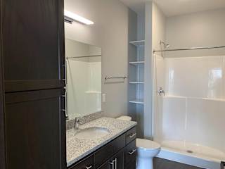 Bathroom with dark brown cabinets in the mocha finish at Haven at Uptown