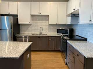 Luxury kitchen with matching stainless steel appliances and large granite counters at Haven at Uptown in Lincoln, Nebraska