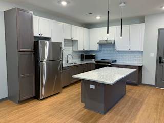 Luxury kitchen with matching stainless steel appliances and large granite counters at Haven at Uptown in Lincoln, Nebraska