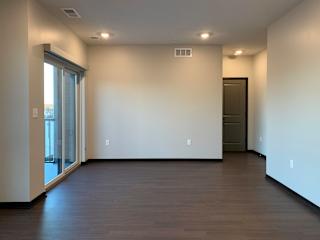 living area with hardwood floors and balcony access