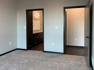 master bedroom with access to walk in closet and private bathroom