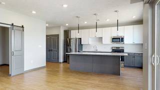 Kitchen island provides additional seating in the Melody floor plan at Haven at Uptown in Lincoln, NE