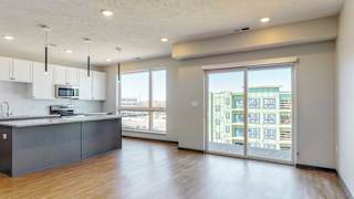 Kitchen and living space with abundant natural light in the Melody floor plan at Haven at Uptown in Lincoln, NE