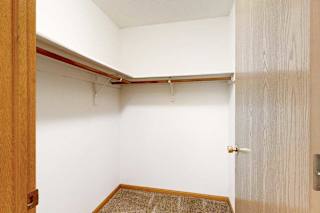Walk-in closet with built-in shelf and hanging rod