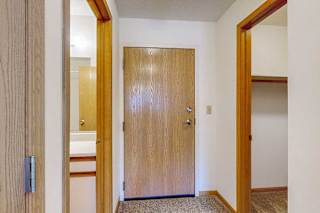 The front door with the bathroom to the left and the closet to the right