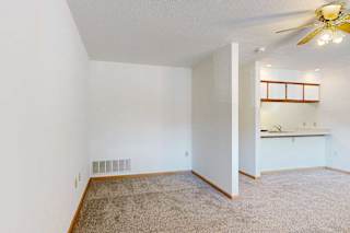 Sleeping area with partial view of kitchen and open layout