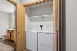 A small laundry room with a washer and dryer.