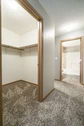 a walk-in closet in the second bedroom and a door open to the attached bathroom