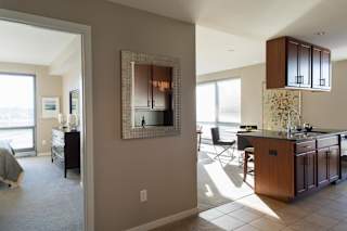 view of door into bedroom and kitchen island and living room