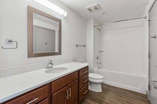 A bathroom with a white sink and a white toilet.