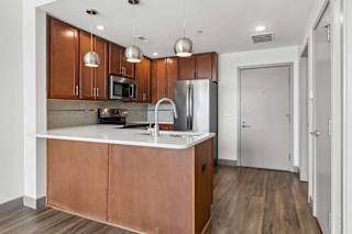 A kitchen with wooden cabinets and a white countertop.