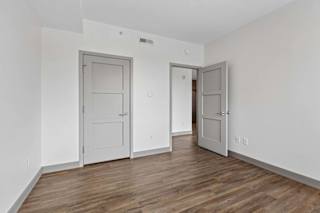A room with two doors and a wooden floor.