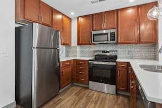 A kitchen with wooden cabinets and stainless steel appliances.