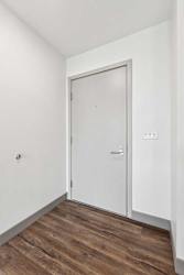 An entryway with a grey front door.