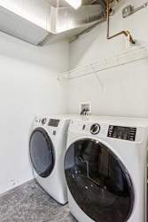 A laundry room with a full-sized side-by-side washer and dryer.
